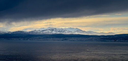 Seascape and snowcapped mountain against sky