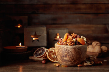 Dried fruits and assorted nuts on a wooden table.