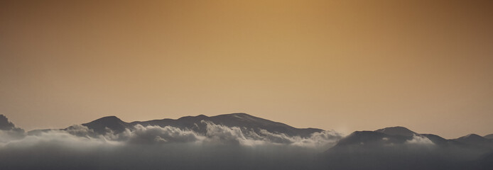 View of silhouettes mountain against clear sky