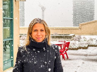 Portrait of woman standing outdoor during snowfall