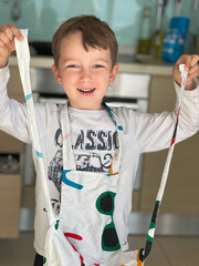 Happy boy wearing apron at home