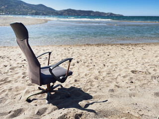 Abandoned office chair at beach on sunny day