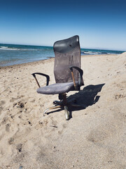 Abandoned office chair at beach
