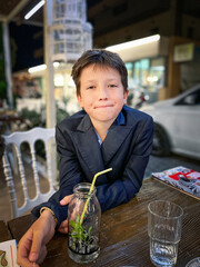 Boy with juice at sidewalk cafe