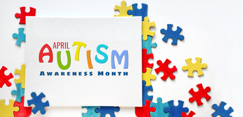 Text, caption World Autism Awareness Day, April 2 written on canvas with puzzle pieces. Design of flyer, poster for Health Care Awareness campaign for Autistic disorder.