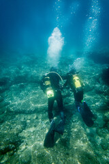 Son and father scuba diving in sea