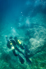 Son and father scuba diving in ocean