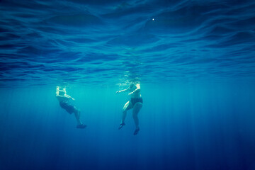 Man and woman swimming in sea