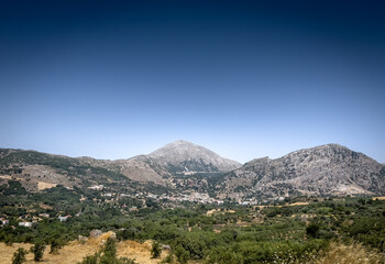 View of landscape and mountain against clear sky