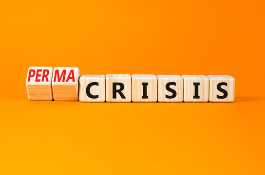 Permacrisis or crisis symbol. Concept words Crisis and Permacrisis on wooden cubes. Beautiful orange table orange background. Business permacrisis or crisis concept. Copy space.