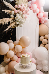 Birthday Cake on a background balloons party decor. Copy space. Trendy Cake. Delicious wedding...