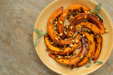 Roasted Red Kuri Squash with sage and pine nuts. Top view.