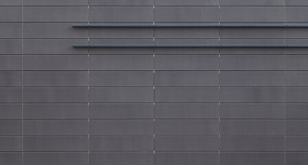 Front view of a new and modern wall or building exterior made of gray slabs. Abstract high resolution full frame textured background.