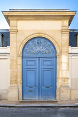 Fototapeta na wymiar Paris, an ancient door, beautiful facade in a luxury neighborhood, rue Saint-Dominique, in the 7e arrondissement 