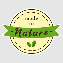 Vector illustration of a round label with the text Made In Nature and green ribbon and leaves