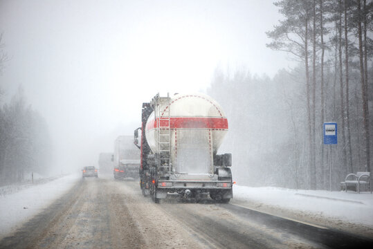 Blurred background of truck on highway in winter. Freight transportation, fuel transportation