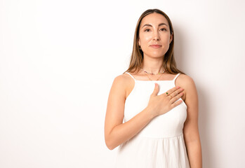Young woman in casual dress Swearing with hand on chest, making a loyalty promise oath - obrazy, fototapety, plakaty