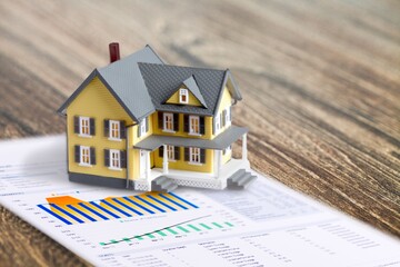 Concept of tax, toy house on the desk