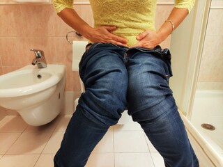 woman sitting on the toilet