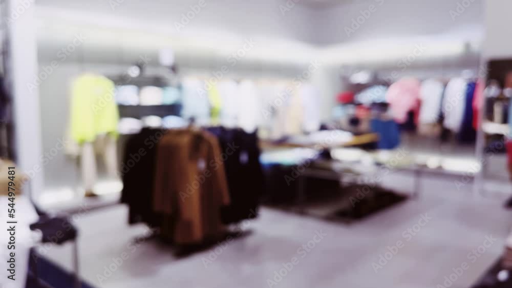 Wall mural fashion, retail and shop, blurred interior view of apparel clothing store in luxury shopping mall as