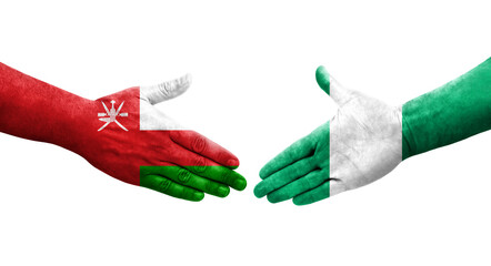 Handshake between Nigeria and Oman flags painted on hands, isolated transparent image.