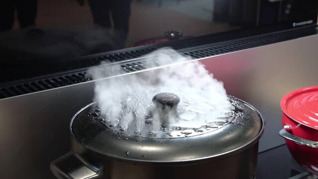 cooker hood for air purification in the kitchen. Boiling stainless steel pot hood