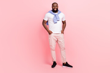 Fototapeta premium Full body image of young good looking groomed man waiting for his girlfriend isolated on pink color background