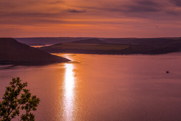 Bakota Canyon of the Dniester River, a violet sunset with picturesque sky and shores on the water, Bakot Bay, Ukraine