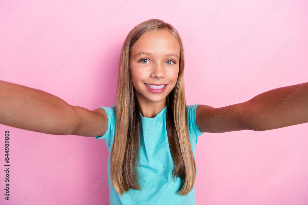 Sticker Photo of cheerful positive small kid wear turquoise t-shirt dark tacking selfie smiling isolated pink color background