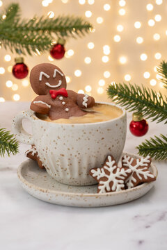 Gingerbread cookie man in a cup of hot chocolate or cappuccino