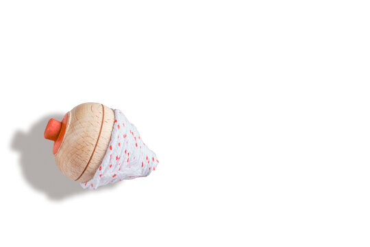 Classic vintage toy top spin with rolled cord isolated white background