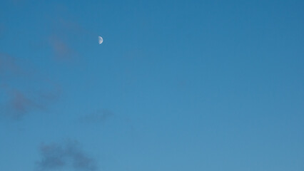 Moon in the blue sky at sunset