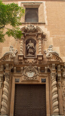 Facade and door of an old church in the city of Valencia (Spain)