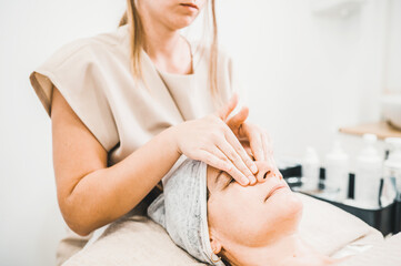 Obraz na płótnie Canvas woman receiving facial treatment in aesthetic clinic