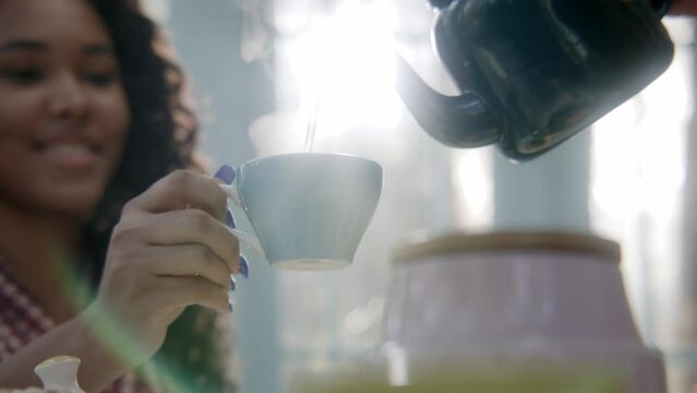 Tea being poured into a cup 