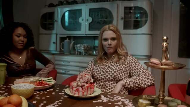 A ginger head girl eating cake with hands