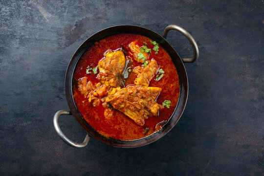 Traditional spicy Indian chicken Madras curry Rogan Josh with drumsticks and wings served as top view in a korei bowl with copy space