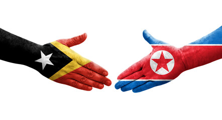 Handshake between North Korea and Timor Leste flags painted on hands, isolated transparent image.