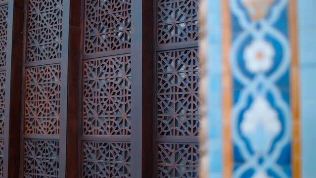 Beautiful decorative wooden grate on the windows of the cultural center. Shot in motion. Closeup. Follow focus