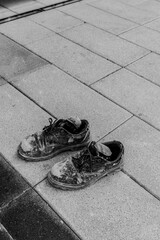 hard work shoes in Dubai street construction worker Conceptual shooting of shoes. Old shabby shoes cementDirty old working boots.