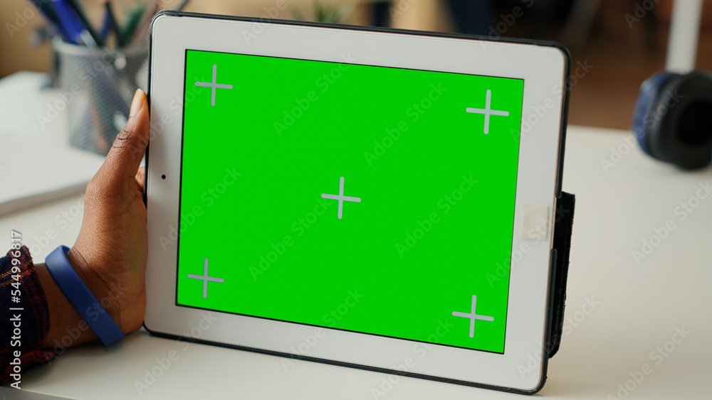 Aufkleber modern person looking at horizontal greenscreen display on tablet at home, using wireless gadget wit