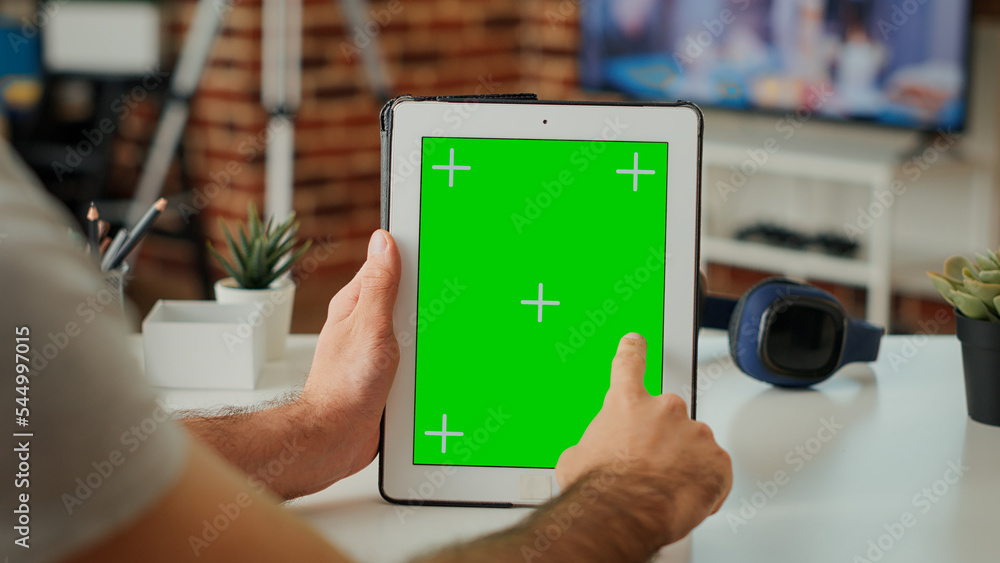 Poster young entrepreneur vertically holding greenscreen template with blank chroma key display and isolate