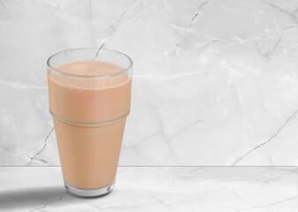 Iced tasty fresh cocoa in glass on desk