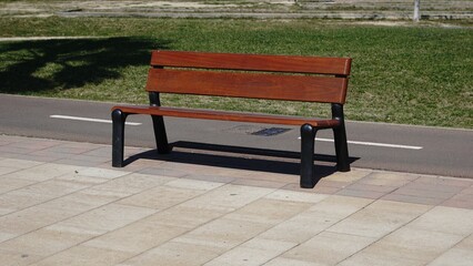 wooden bench on pedestrian sidewalk