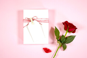 Gift tag, thank you card, 2x3.5 blank card mockup. Valentine's day wedding love theme styled with a single red rose and lipstick chocolate against a pale blush pink background.