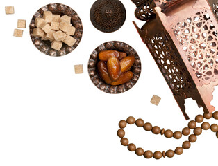 Arabic lantern and plate with date fruits on the table