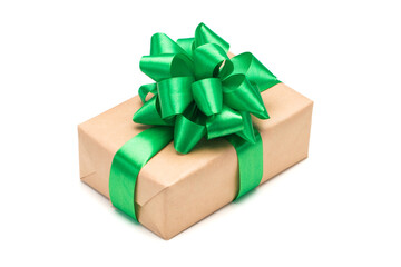 Close up shot of gift box wrapped in craft paper and decorated with green satin ribbon bow, isolated on white background