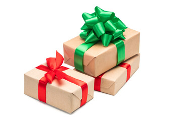 Close up set of three gift boxes wrapped in craft paper and decorated with satin ribbon bows, isolated on white background