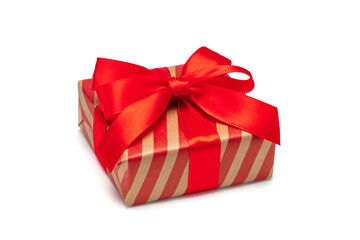Close up shot of gift box wrapped in striped craft paper and decorated with satin ribbon bow, isolated on white background