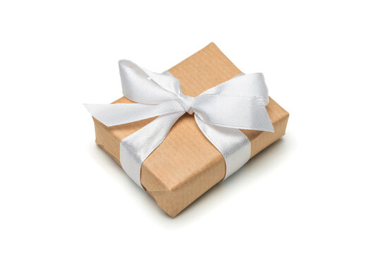 Close up shot of gift box wrapped in craft paper and decorated with satin ribbon bow, isolated on white background